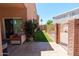 Cozy backyard patio featuring a comfortable seating area, a glimpse of a neighboring yard and a glimpse of a pool at 111 N Soho Pl, Chandler, AZ 85225