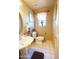 Cozy bathroom features a pedestal sink, toilet, window, and neutral decor at 111 N Soho Pl, Chandler, AZ 85225