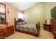 Spacious bedroom with a large bed, coordinating furniture, and soft, neutral carpeting at 111 N Soho Pl, Chandler, AZ 85225