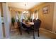 Formal dining room with large table, upholstered chairs, and natural light from windows at 111 N Soho Pl, Chandler, AZ 85225