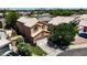 Aerial view of a two-story home featuring a tile roof, landscaped yard, and attached garage at 111 N Soho Pl, Chandler, AZ 85225