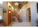 Inviting foyer with wood-trimmed staircase and tile flooring at 111 N Soho Pl, Chandler, AZ 85225