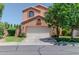 Two-story home featuring a front-facing garage and well-maintained landscaping at 111 N Soho Pl, Chandler, AZ 85225