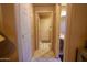 Hallway view highlighting the interior doors, tile flooring, and access to different rooms at 111 N Soho Pl, Chandler, AZ 85225