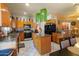 Open kitchen with wooden cabinets, island with granite countertop, and modern appliances at 111 N Soho Pl, Chandler, AZ 85225