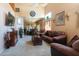 Open-concept living room with neutral carpet, high ceilings, and view of dining area at 111 N Soho Pl, Chandler, AZ 85225