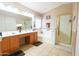 Spacious main bathroom featuring double sinks, separate shower, large mirror, and bathtub at 111 N Soho Pl, Chandler, AZ 85225