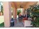 Covered patio with comfortable seating, ceiling fan, and views of the green backyard at 111 N Soho Pl, Chandler, AZ 85225