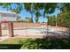 Fenced-in pool area with a sparkling pool, poolside seating, and manicured landscaping, ideal for summer fun at 111 N Soho Pl, Chandler, AZ 85225