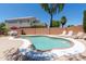 Outdoor pool area featuring lounge chairs and verdant trees providing a private, relaxing retreat at 111 N Soho Pl, Chandler, AZ 85225