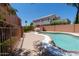 Inviting pool with a unique shape, surrounded by a concrete patio and privacy fencing, perfect for entertaining at 111 N Soho Pl, Chandler, AZ 85225