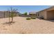 Backyard featuring rock landscaping, trees, and an AC unit at 11303 E Sunflower Ct, Florence, AZ 85132