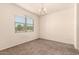 Bright bedroom features neutral walls, carpet flooring, and ample natural light from a large window at 11303 E Sunflower Ct, Florence, AZ 85132