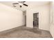 Inviting bedroom features neutral walls and carpet flooring, with access to an en-suite bathroom at 11303 E Sunflower Ct, Florence, AZ 85132