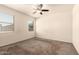 Cozy bedroom features neutral walls, carpet flooring, and large windows that offer ample natural light at 11303 E Sunflower Ct, Florence, AZ 85132