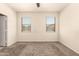 Bright bedroom with neutral walls, carpet flooring, and dual windows for abundant natural light at 11303 E Sunflower Ct, Florence, AZ 85132