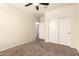 Cozy bedroom with neutral walls, carpet, closet and ceiling fan at 11303 E Sunflower Ct, Florence, AZ 85132