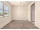 Simple dining room features a modern chandelier and a large window for natural light at 11303 E Sunflower Ct, Florence, AZ 85132
