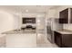 Well-equipped kitchen boasts granite countertops, stainless steel appliances, and dark wood cabinetry at 11303 E Sunflower Ct, Florence, AZ 85132