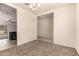 Open living space showcases neutral walls, plush carpet, and seamless flow to the kitchen at 11303 E Sunflower Ct, Florence, AZ 85132