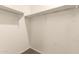 Walk-in closet with ample shelving and carpet flooring for organized storage at 11303 E Sunflower Ct, Florence, AZ 85132