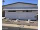Charming single-story home with a grey trim, three white decorative flowerpots, and well-kept landscaping at 11411 N 91St Ave # 188, Peoria, AZ 85345
