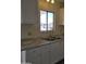 Kitchen featuring white cabinets, updated countertops, and a stainless steel sink at 11411 N 91St Ave # 188, Peoria, AZ 85345