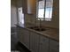 Kitchen featuring white cabinets, updated countertops, and a stainless steel sink at 11411 N 91St Ave # 188, Peoria, AZ 85345