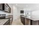 Modern kitchen featuring an island with a sink, stainless steel appliances and sleek granite countertops at 11891 E Cliffrose Ln, Florence, AZ 85132