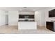 Modern kitchen with an island, granite countertops, and stainless steel appliances offers both style and functionality at 11891 E Cliffrose Ln, Florence, AZ 85132
