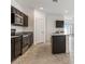 Beautiful kitchen featuring granite countertops, dark cabinets and stainless steel appliances for a touch of elegance at 11891 E Cliffrose Ln, Florence, AZ 85132