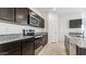 Well-equipped kitchen with stainless steel appliances, dark cabinetry, and granite countertops provides a modern culinary space at 11891 E Cliffrose Ln, Florence, AZ 85132