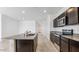 Open kitchen featuring an island, granite countertops, and stainless steel appliances, ideal for cooking and socializing at 11891 E Cliffrose Ln, Florence, AZ 85132