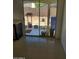 Indoor view of back patio through sliding door, with potted plants and outdoor decorations at 11936 W Charter Oak Rd, El Mirage, AZ 85335