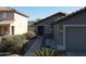 A cozy home with a front yard featuring desert landscaping, bushes, and a walkway to the front door at 11936 W Charter Oak Rd, El Mirage, AZ 85335