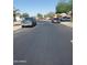 A residential street with parked cars and houses in the background at 11936 W Charter Oak Rd, El Mirage, AZ 85335