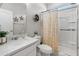 Bright bathroom featuring a white vanity, shower, and modern decor at 12236 W Country Club Ct, Sun City, AZ 85373
