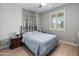 Comfortable bedroom with a full sized bed, plantation shutters, and laminate wood flooring at 12236 W Country Club Ct, Sun City, AZ 85373