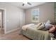 Cozy bedroom featuring a plush bed, wood flooring, and a window with natural lighting at 12236 W Country Club Ct, Sun City, AZ 85373