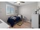 bedroom featuring a twin bed, laminate wood flooring, and plantation shutters at 12236 W Country Club Ct, Sun City, AZ 85373