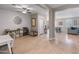 Bonus room with light wood floors, a windmill wall decoration, and a view of the dining room and living room at 12236 W Country Club Ct, Sun City, AZ 85373