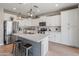 Modern kitchen with stainless steel appliances, a kitchen island, and white cabinetry at 12236 W Country Club Ct, Sun City, AZ 85373