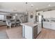 Spacious open-concept layout with a kitchen island, dining area, and living room at 12236 W Country Club Ct, Sun City, AZ 85373