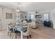 Open-concept living and dining area with hardwood floors and modern furnishings at 12236 W Country Club Ct, Sun City, AZ 85373