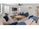 Comfortable living room with a large sofa, ceiling fan, and bright windows providing natural light at 12236 W Country Club Ct, Sun City, AZ 85373