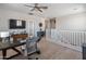 Spacious loft area with an office area and a dark wood desk at 12236 W Country Club Ct, Sun City, AZ 85373