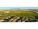 Scenic aerial view of the community featuring new construction, green space and mountain views at 14861 W Ashland Ave, Goodyear, AZ 85395