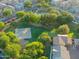 Aerial view showcasing a community park featuring a basketball court and mature trees at 14861 W Ashland Ave, Goodyear, AZ 85395