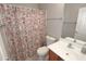 Bathroom featuring a floral shower curtain, a single sink vanity, and neutral wall color at 14861 W Ashland Ave, Goodyear, AZ 85395