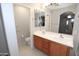 Bathroom showcasing a double sink vanity, tiled floors, and modern fixtures at 14861 W Ashland Ave, Goodyear, AZ 85395